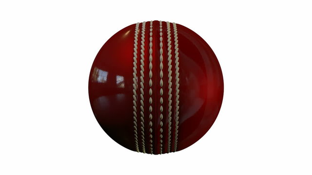 A shiny reflective red leather cricket ball spinning around on an isolated white background