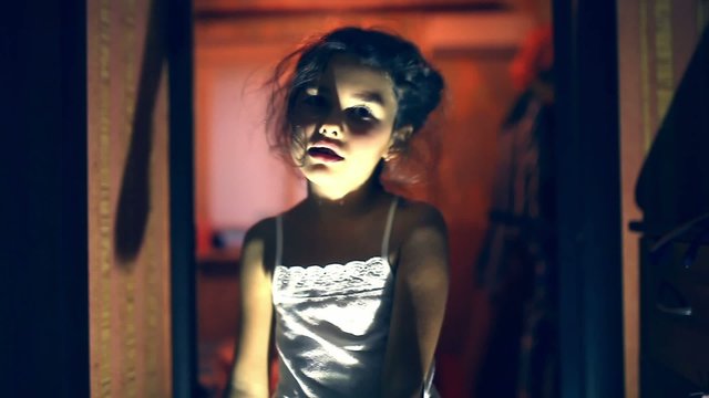 teen  girl zombie is orange silhouette stretched indoor hands
