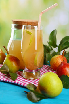 Fresh pear juice with fruit on bright background