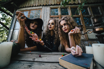 Three vintage witches perform magic ritual