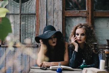 Two vintage witches perform magic ritual