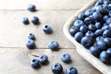 Tasty ripe blueberries on wooden table close up