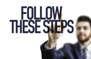Business man pointing the text: Follow These Steps