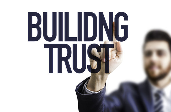 Business man pointing the text: Building Trust