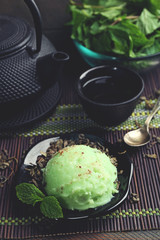 Homemade Green tea ice-cream on bamboo mat, on wooden background