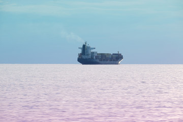The image of a cargo ship in a open sea