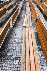 empty wooden benches on urban square in autumn