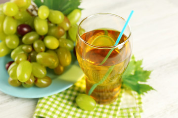 Bunch of grape with glass on wooden table
