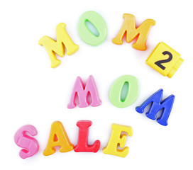 Concept of childish goods sale - magnetic plastic letters isolated on white background