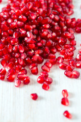 pomegranate seeds on wooden surface