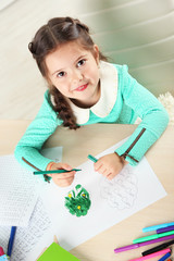 Cute little girl doing her homework, close-up