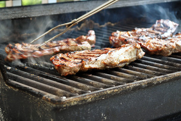 Pork chops sizzling on the grill