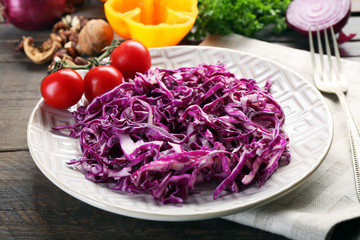 Red cabbage salad served on plate closeup