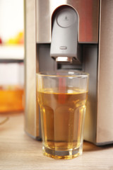 Juicer and pear juice on kitchen table
