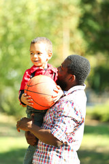 Father and son playing with ball outside