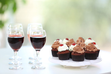 Tasting of wine and chocolate cupcakes, close up
