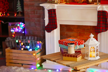 Fireplace with beautiful Christmas decorations in comfortable living room