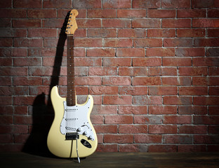 Obraz na płótnie Canvas Guitar on brick wall background