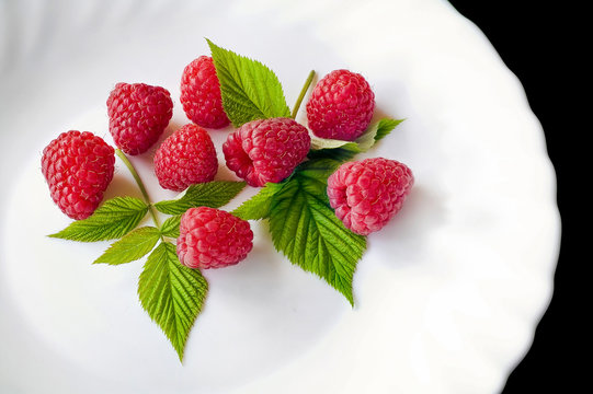 Delicious first class fresh raspberries in plate