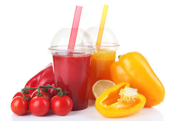 Fresh vegetable juices in plastic cups isolated on white