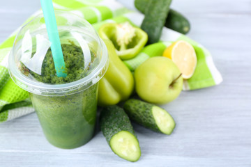 Fresh vegetable juice on color wooden background