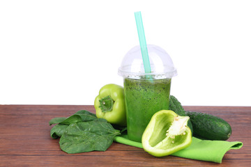 Fresh vegetable juice on color wooden table, on bright background