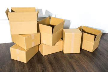 Pile of cardboard boxes on white background with box shadow