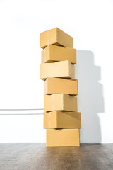 Pile of cardboard boxes on white background with box shadow