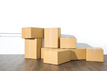 Pile of cardboard boxes on white background with box shadow