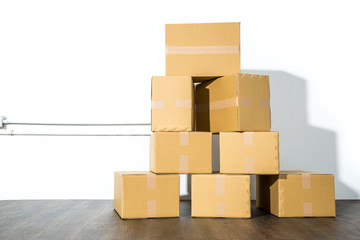Pile of cardboard boxes on white background with box shadow