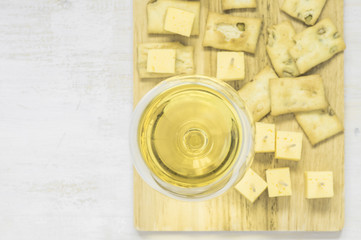 Glass of wine on the board with snacks
