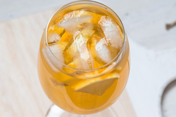 Wineglass of white sangria with lemon and ice