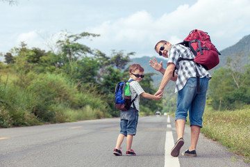 Fototapeta premium Father and son walking on the road.
