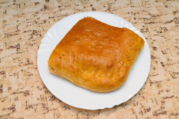  Piece of the pie with potatoes and cabbage on plate.