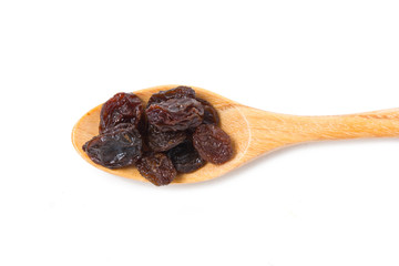Raisin with wooden spoon isolated on white.
