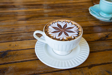 Latte Coffee art on the wooden desk.