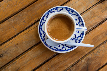 cup of espresso on a wooden background table.