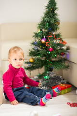 Baby near Christmas tree