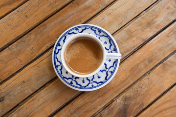 cup of espresso on a wooden background table.