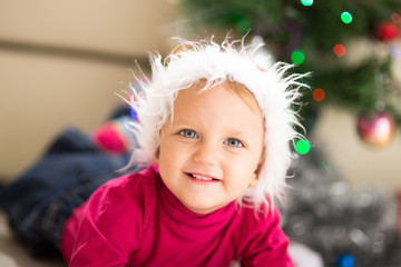 Baby near Christmas tree