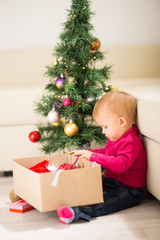 Fototapeta na wymiar Baby near Christmas tree