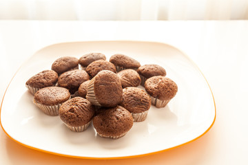 Tasty chocolate muffins in a white plate