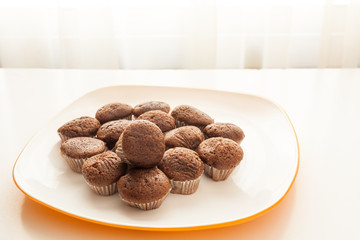 Tasty chocolate muffins in a white plate