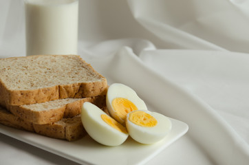 Fototapeta premium Easy Breakfast with Whole Grain Bread, Boiled Egg and Milk.