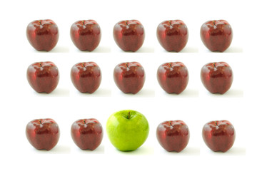 Group of red apples with one green apple in the middle