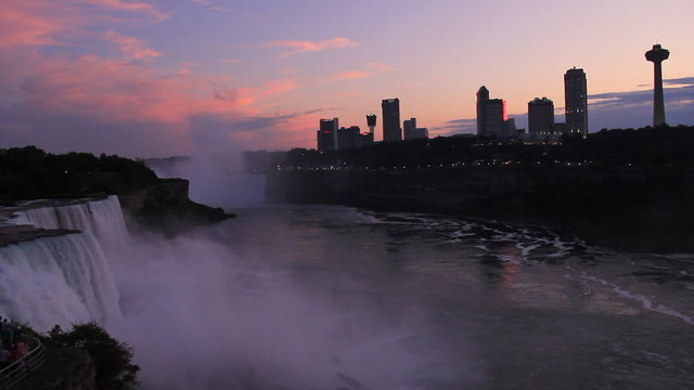 Niagara Falls Twilight Skyline. Minutes after sunset on a beautiful summer day in Niagara Falls. Shot from the observation deck on the American side. Some tourists visible in lower left corner.