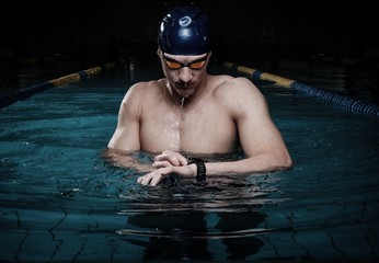 Swimmer with heart rate monitor in swimming pool