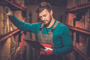 Worker on a automotive spare parts warehouse