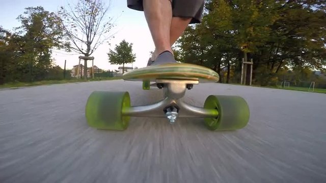 4K Front view of a man riding his longboard