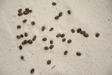 Fototapeta na wymiar Coffee bean on beautiful white sand